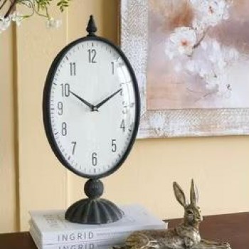 ساعه طاوله بيضاوية سوداء عتيقة ذات وجه أبيض وقاعدة عموديةL8616